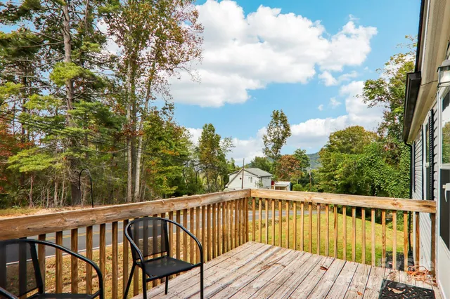 a view of balcony with wooden floor and fence