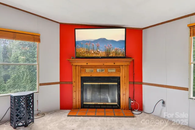 a living room with a fireplace and a large window