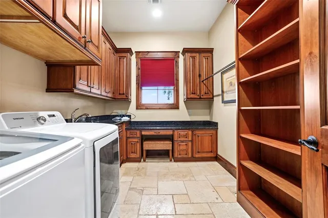 a utility room with sink dryer and washer