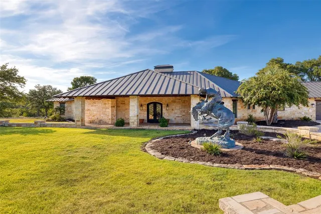 a front view of a house with garden