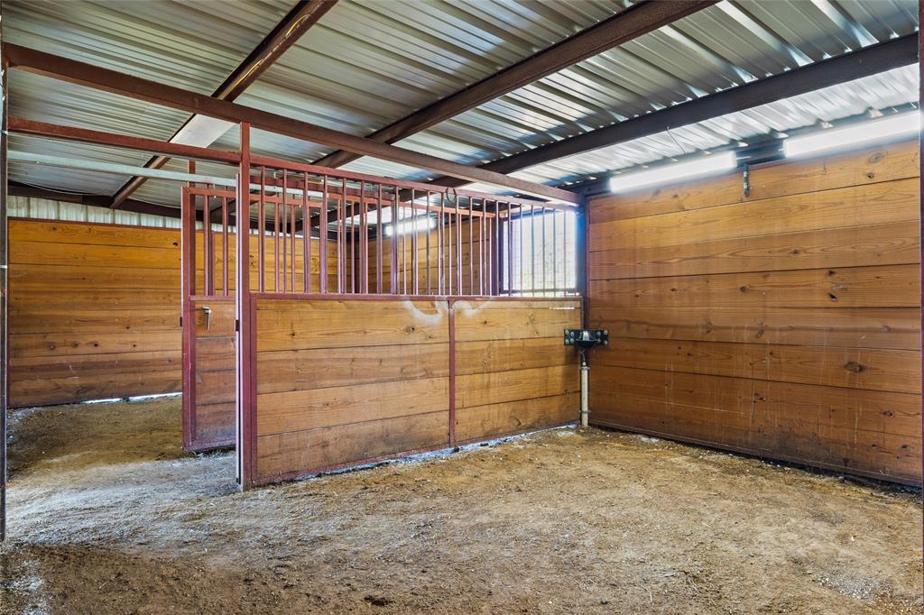 4451 Shiloh Road Midlothian, TX 76065 - Photo 31 of 39 Barn has 3 interior horse stables with paddle style automatic horse waterer. Barn also has 3 exterior stables. Cement water trough outside will convey.