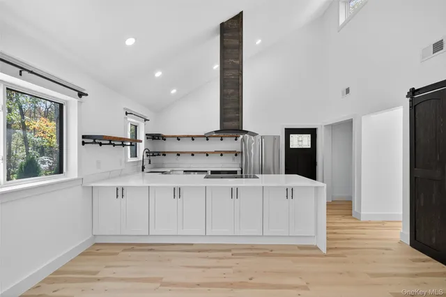a kitchen with stainless steel appliances a refrigerator and a stove top oven