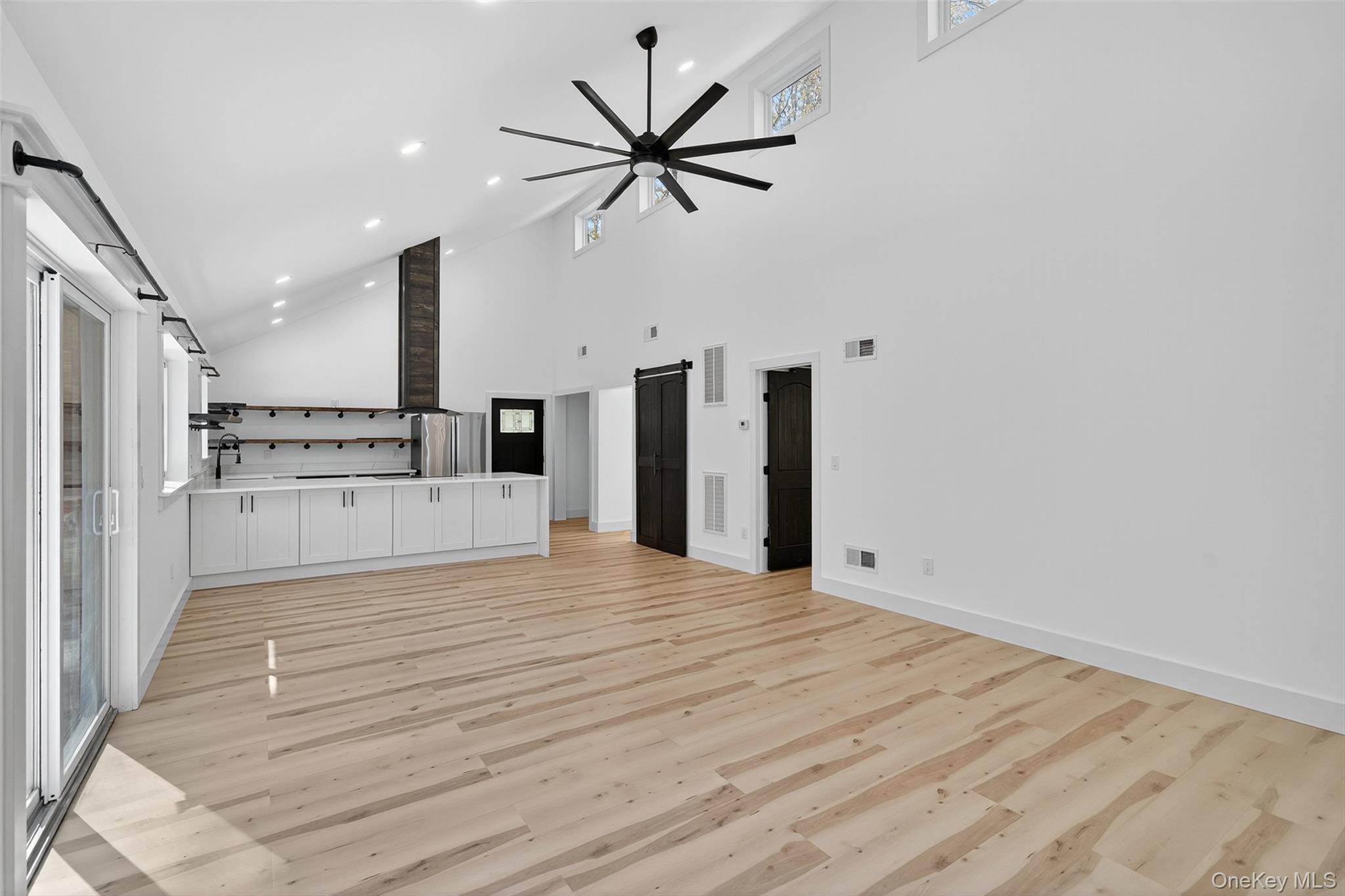 273 Perry Pond Road Narrowsburg, NY 12764 - Photo 14 of 49 Unfurnished living room with high vaulted ceiling, light wood-type flooring, ceiling fan, and recessed lighting