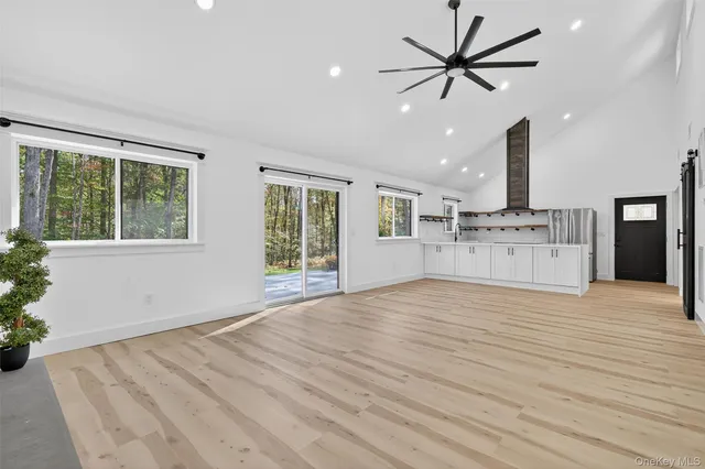 a view of an empty room with a kitchen