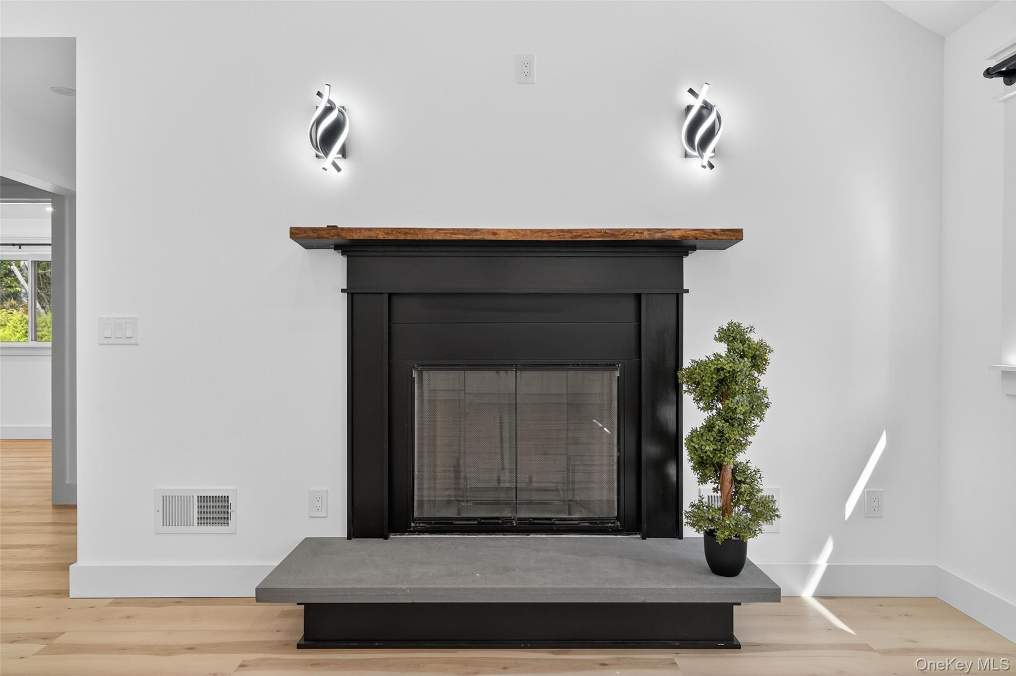 273 Perry Pond Road Narrowsburg, NY 12764 - Photo 20 of 49 Detailed view of wood finished floors and a fireplace with raised hearth