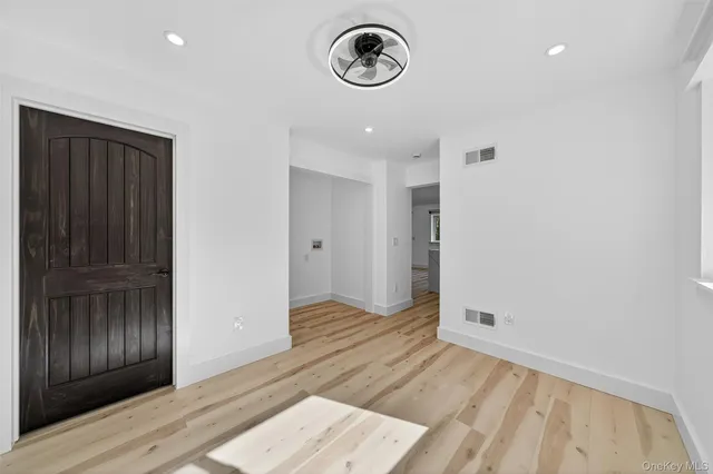 a view of a room with wooden floor and window