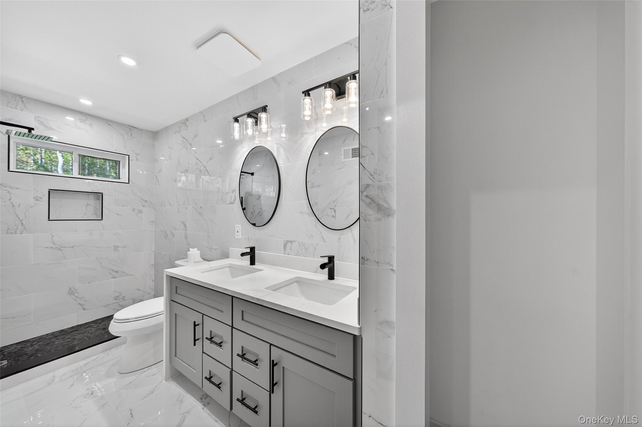 273 Perry Pond Road Narrowsburg, NY 12764 - Photo 28 of 49 Full bathroom featuring light marble finish flooring, double vanity, tile walls, recessed lighting, and a marble finish shower
