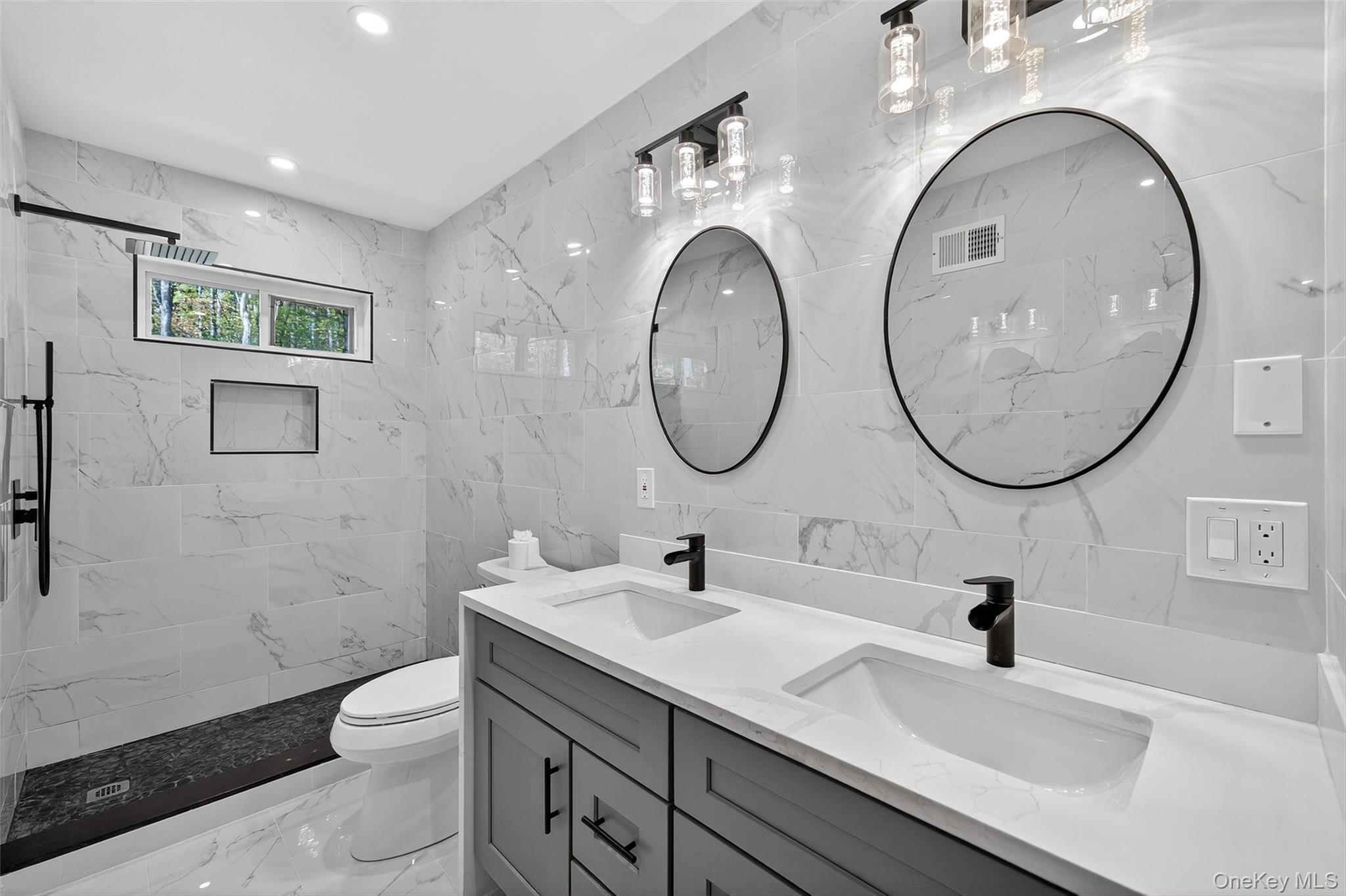 273 Perry Pond Road Narrowsburg, NY 12764 - Photo 29 of 49 Full bath with tile walls, double vanity, light marble finish floors, a marble finish shower, and recessed lighting