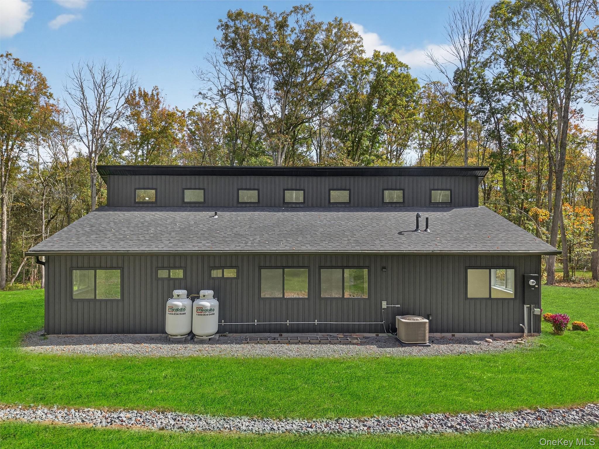 273 Perry Pond Road Narrowsburg, NY 12764 - Photo 42 of 49 Rear view of house with roof with shingles, a lawn, and view of scattered trees