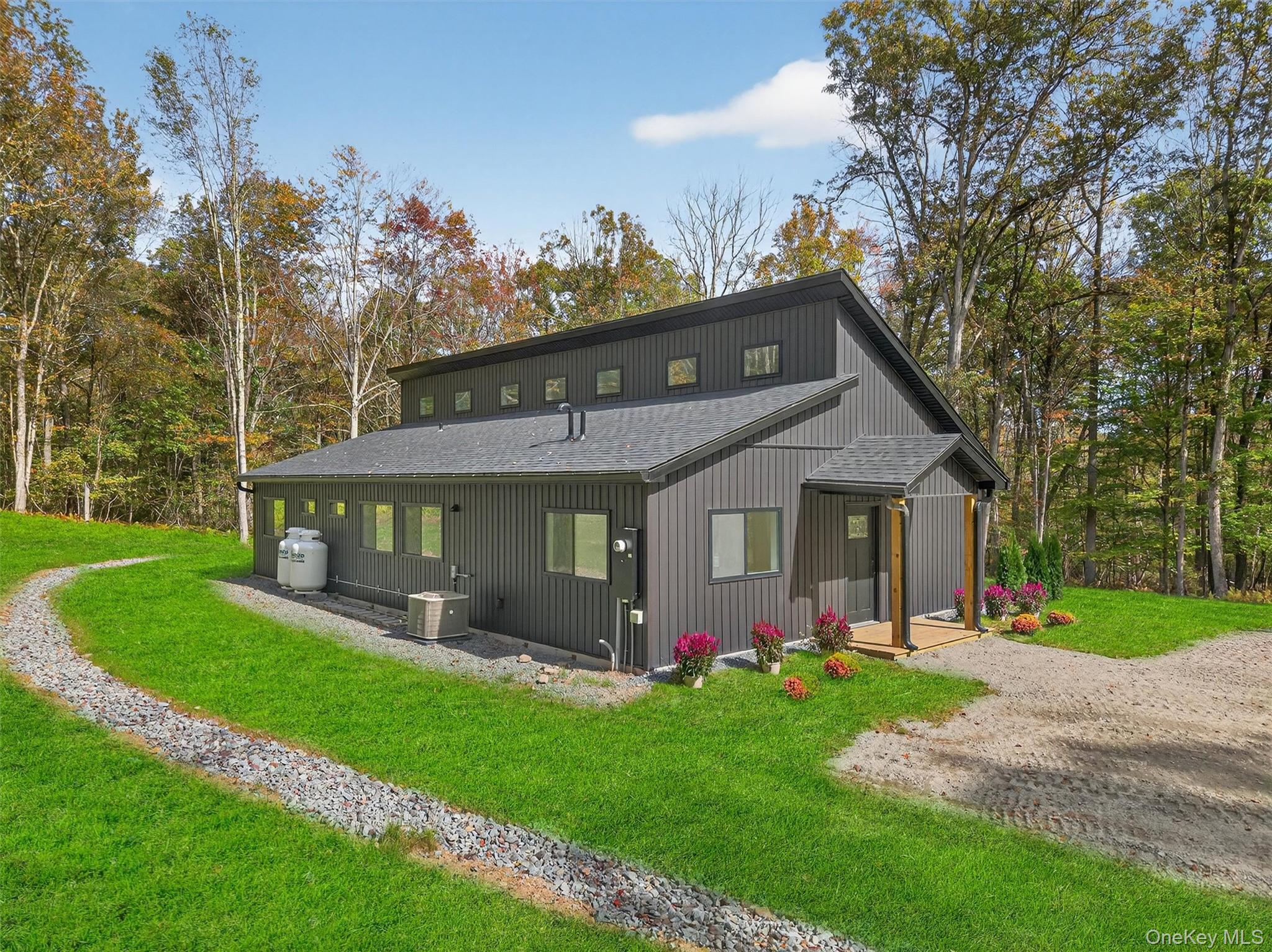 273 Perry Pond Road Narrowsburg, NY 12764 - Photo 9 of 49 Rear view of property with roof with shingles and a yard