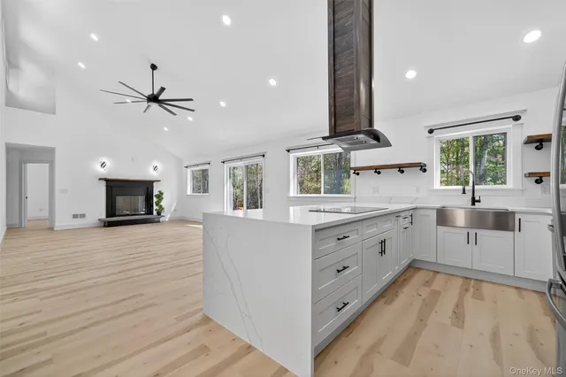 a kitchen with stainless steel appliances kitchen island granite countertop a stove and a sink