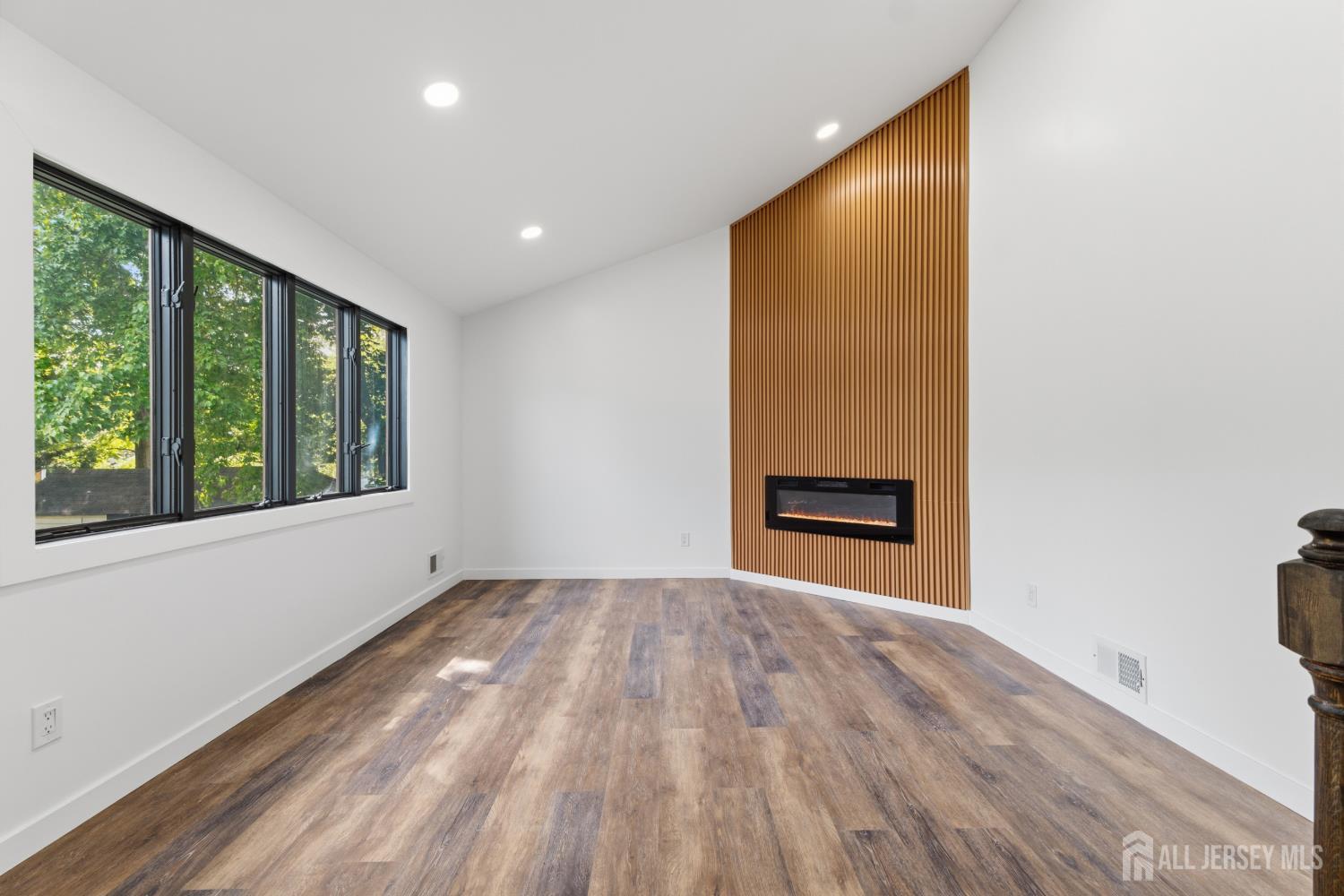 12 Daniel Road Spotswood, NJ 08884 - Photo 5 of 27 a view of an empty room with a window and wooden floor