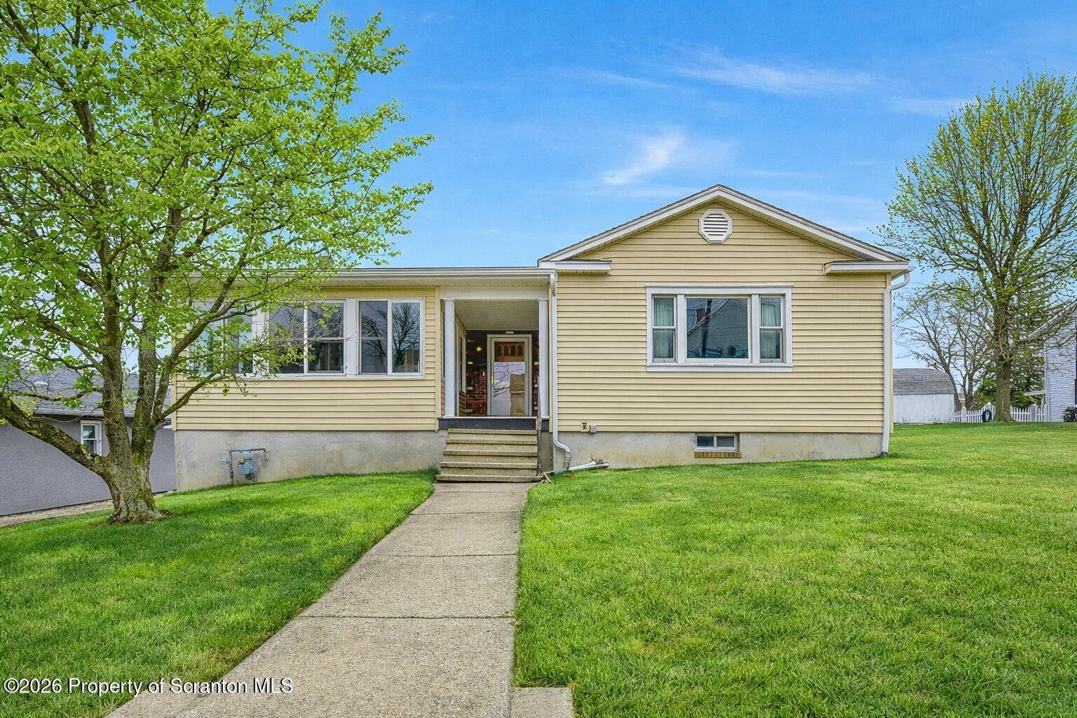 211 Green Street Dunmore, PA 18512 - Photo 1 of 38 a front view of a house with yard