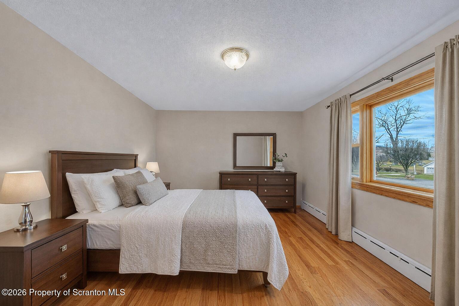 211 Green Street Dunmore, PA 18512 - Photo 11 of 38 a bedroom with a bed and wooden floor