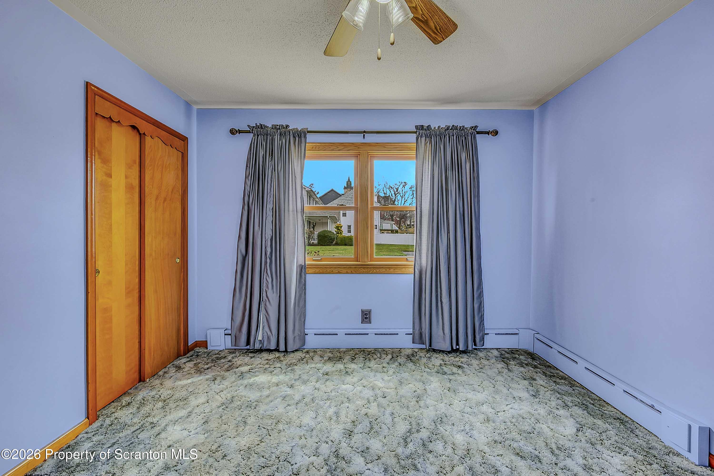 211 Green Street Dunmore, PA 18512 - Photo 13 of 38 an empty room with window and doors