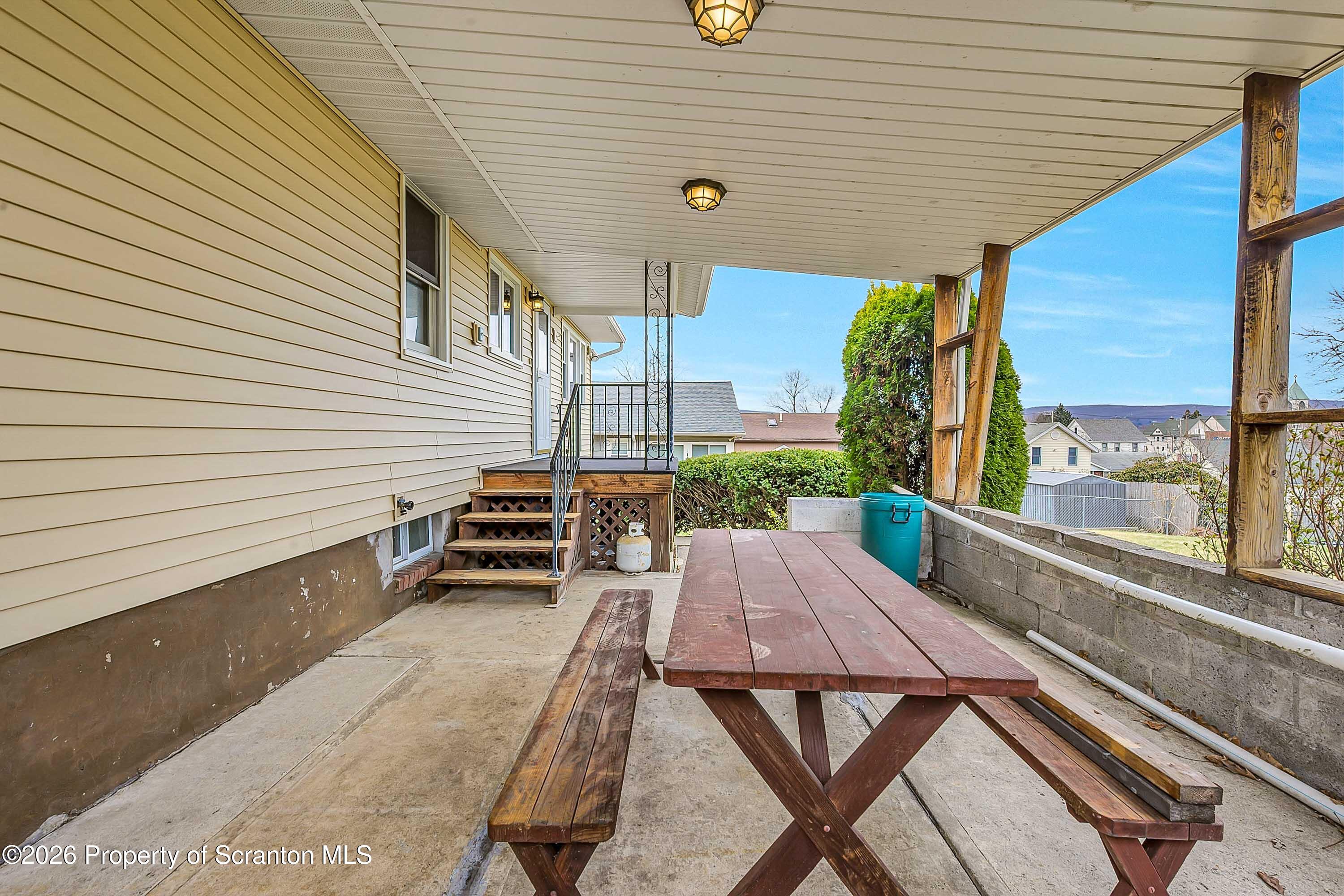 211 Green Street Dunmore, PA 18512 - Photo 18 of 38 a view of a patio with table and chairs and wooden floor