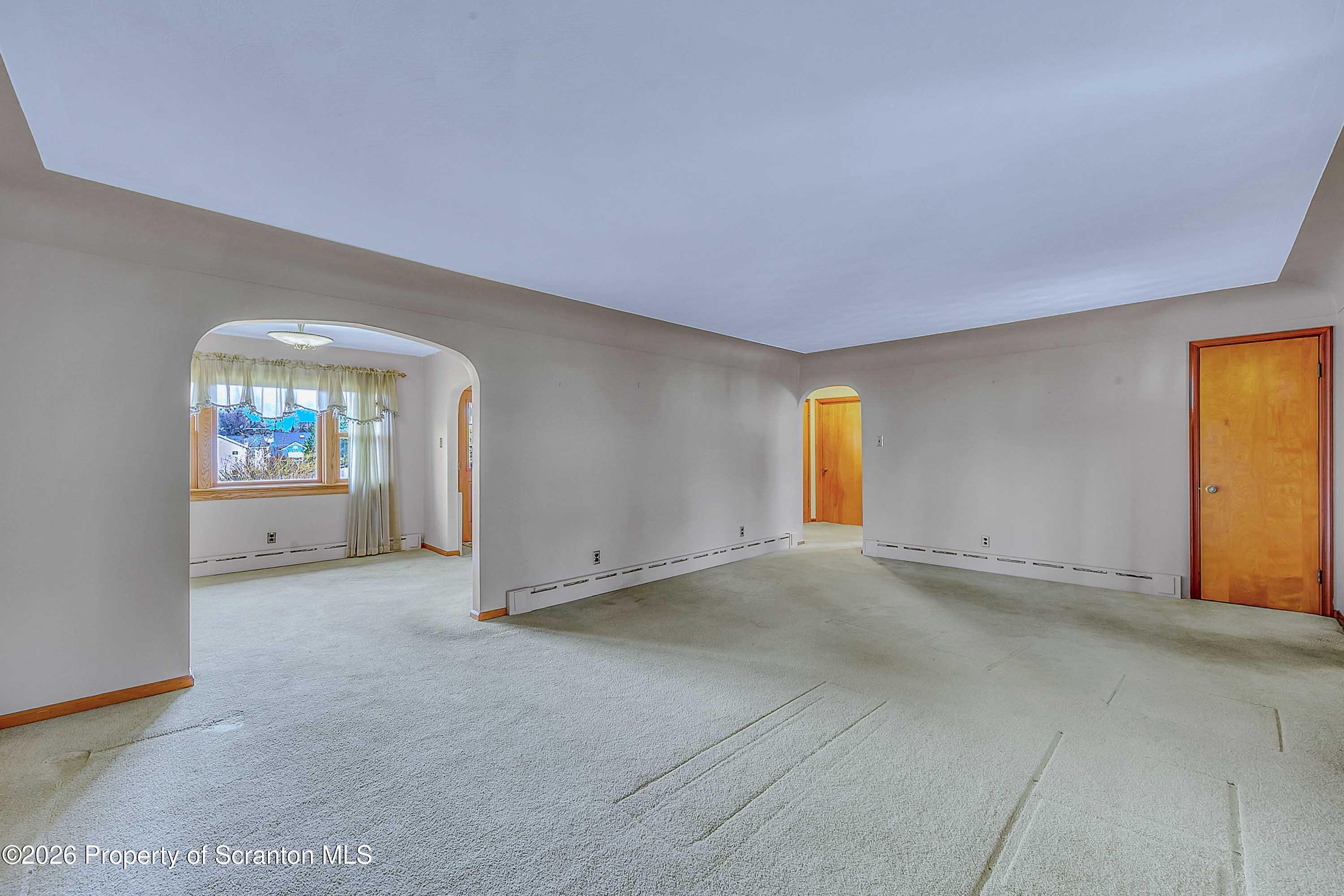 211 Green Street Dunmore, PA 18512 - Photo 20 of 38 an empty room with a window and fireplace