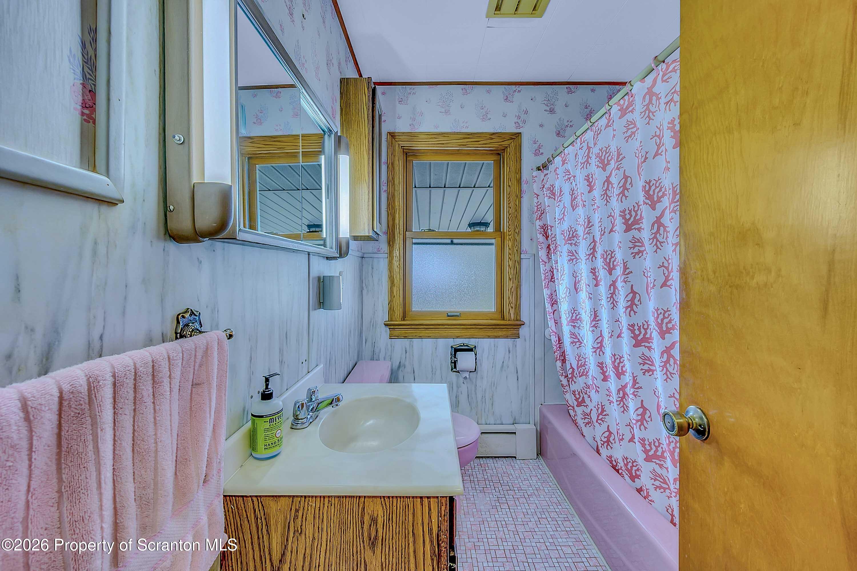 211 Green Street Dunmore, PA 18512 - Photo 21 of 38 a bathroom with a sink and a mirror