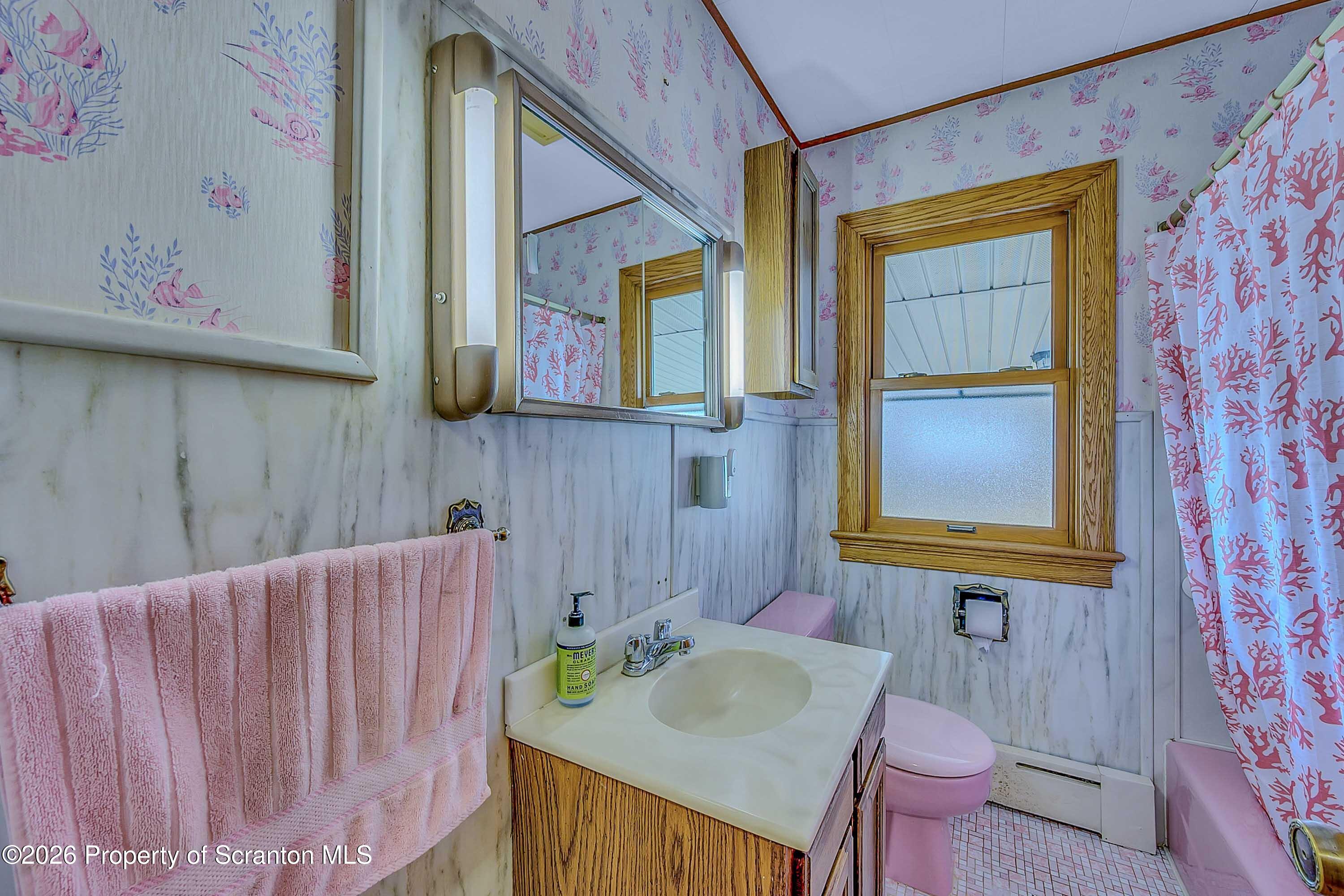 211 Green Street Dunmore, PA 18512 - Photo 22 of 38 a bathroom with a sink and a mirror