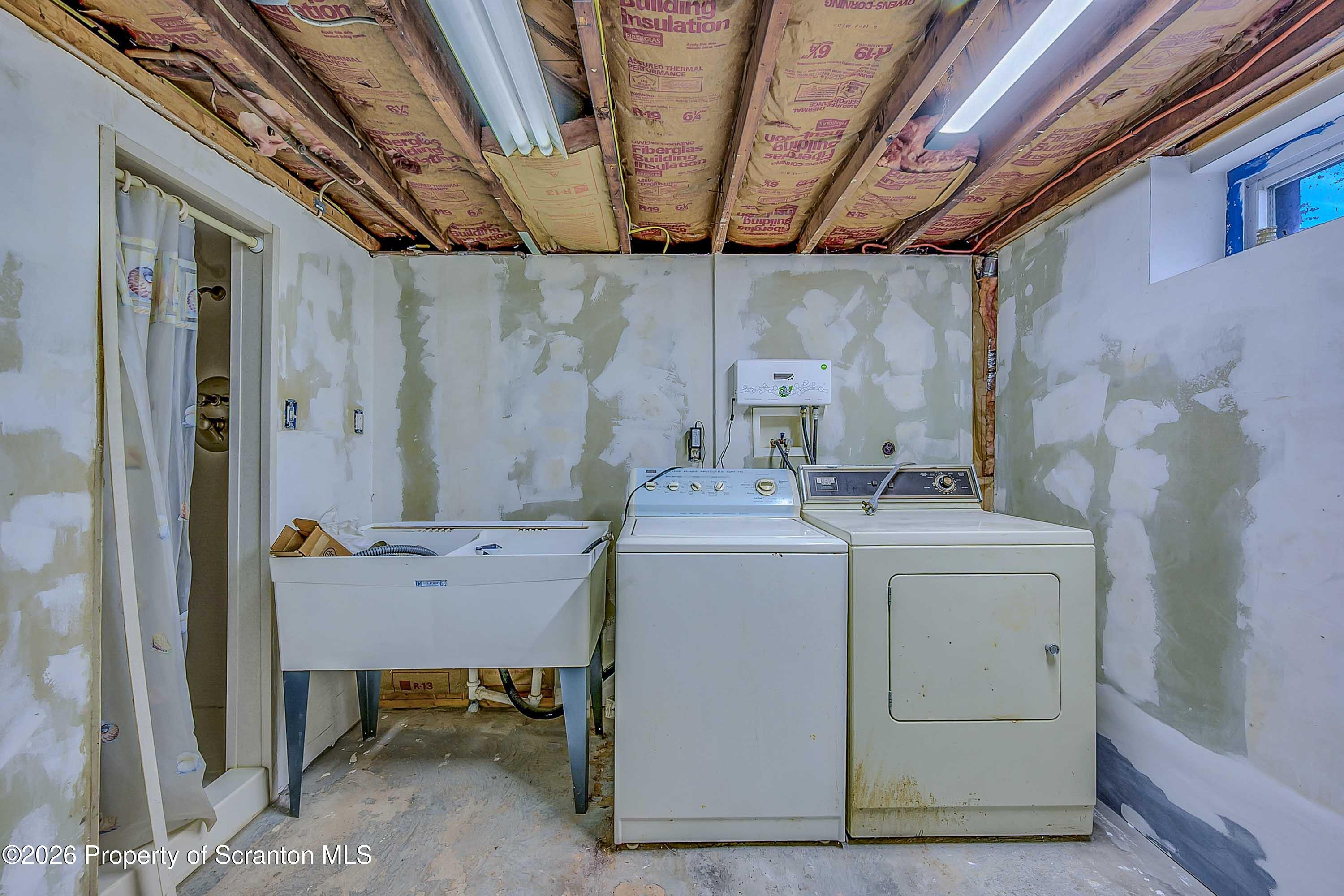 211 Green Street Dunmore, PA 18512 - Photo 31 of 38 a utility room with dryer and washer