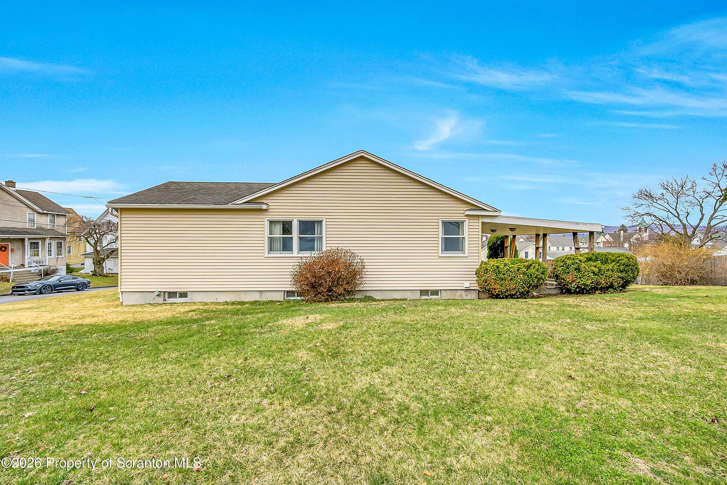 211 Green Street Dunmore, PA 18512 - Photo 36 of 38 a view of a yard in front of a house with a large tree