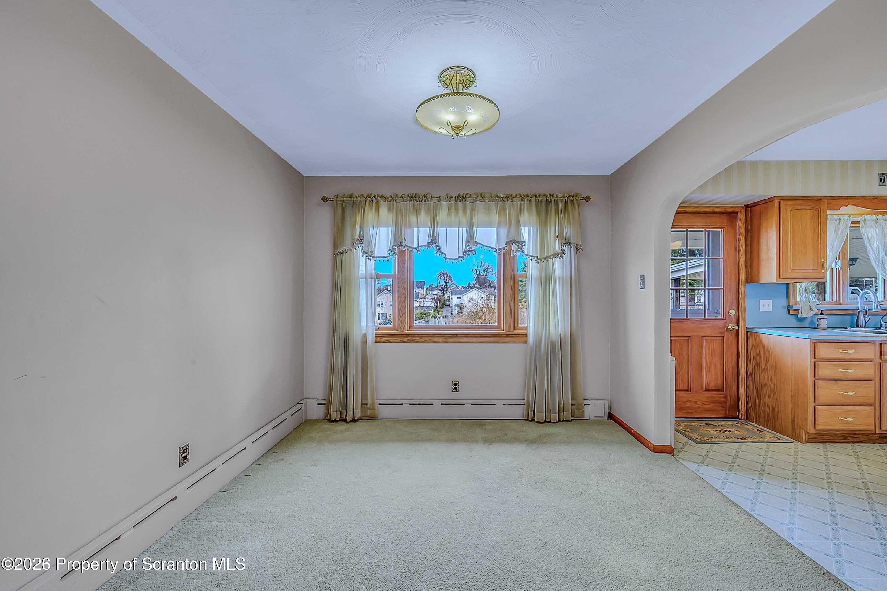 211 Green Street Dunmore, PA 18512 - Photo 5 of 38 an empty room with window and mirror