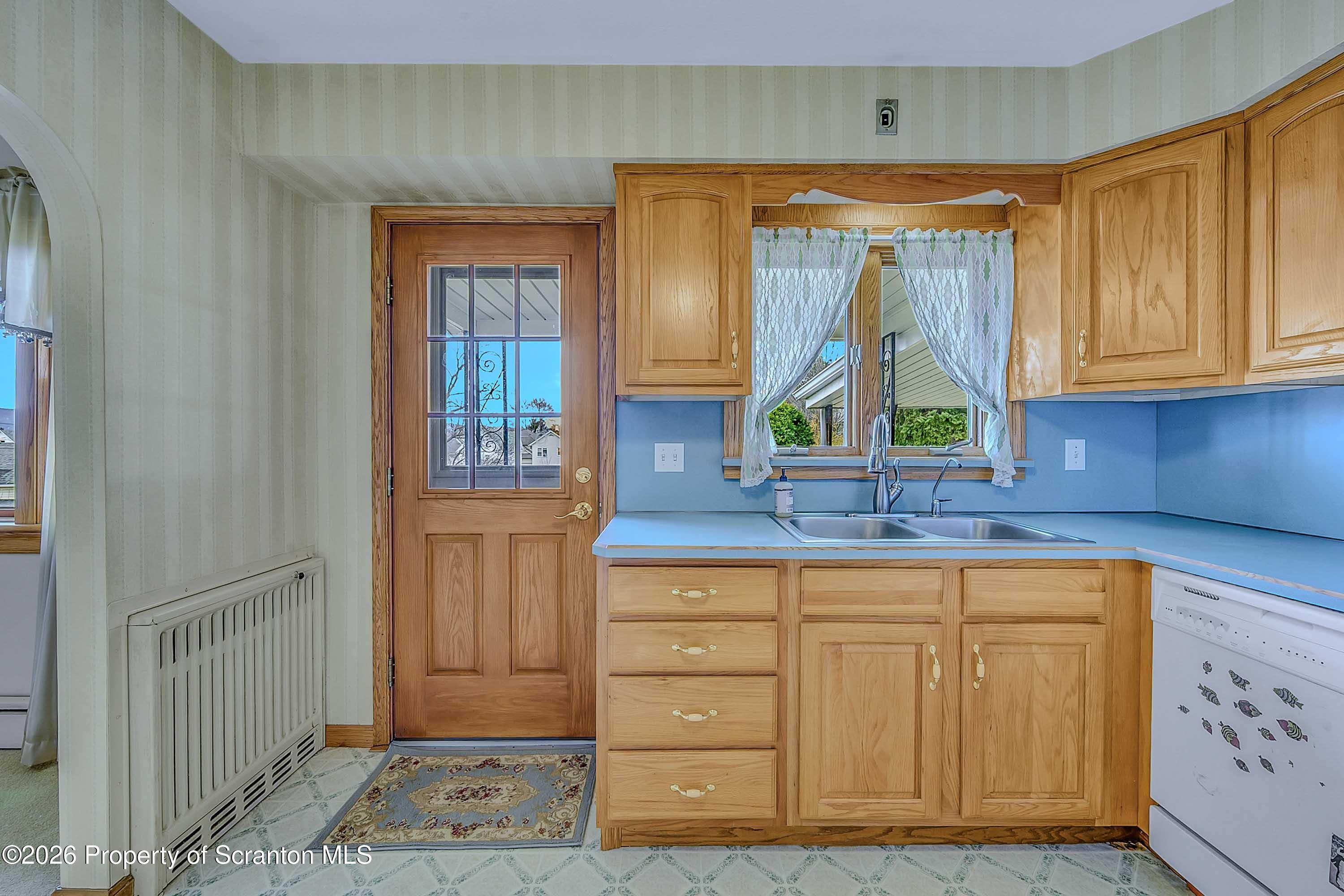 211 Green Street Dunmore, PA 18512 - Photo 9 of 38 a kitchen with a wooden cabinets and a window