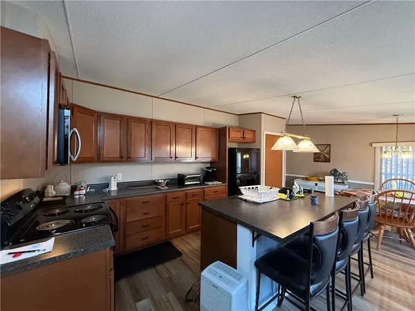 a kitchen with granite countertop a sink stove and cabinets