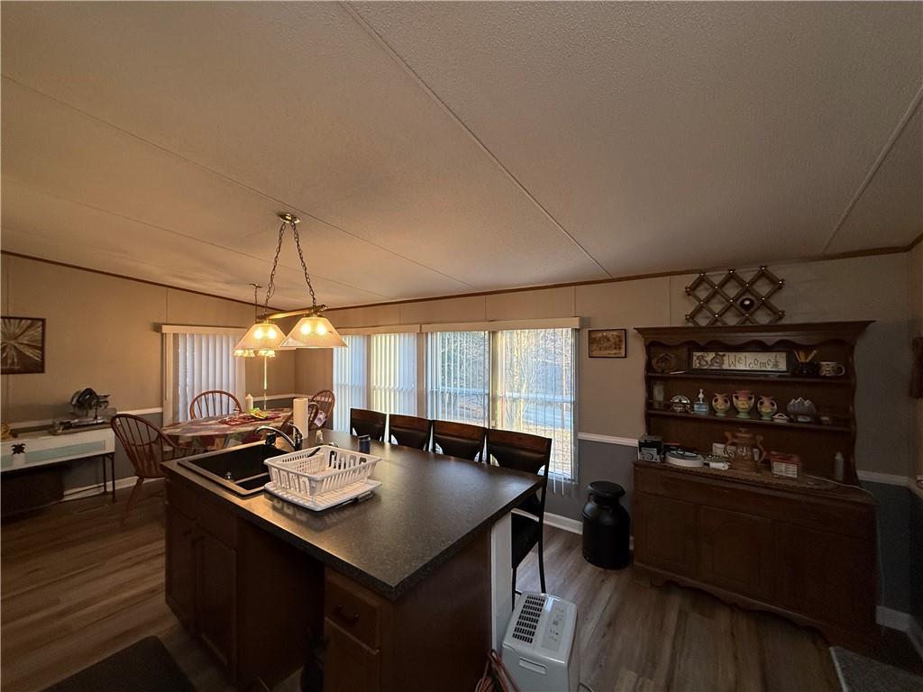 1106 Gary Road Rockwood, PA 15557 - Photo 14 of 46 a kitchen with a sink dishwasher and a stove with wooden floor
