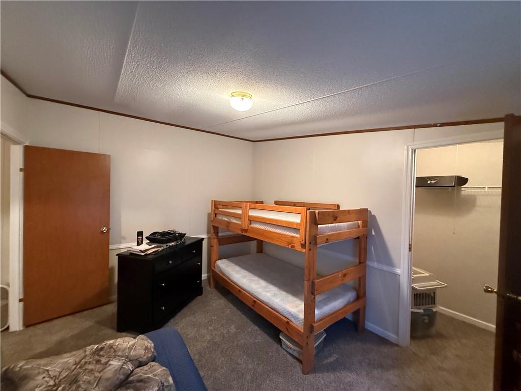 1106 Gary Road Rockwood, PA 15557 - Photo 27 of 46 a bedroom with a bed and a dresser