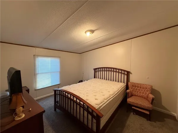 a bedroom with a bed and a desk
