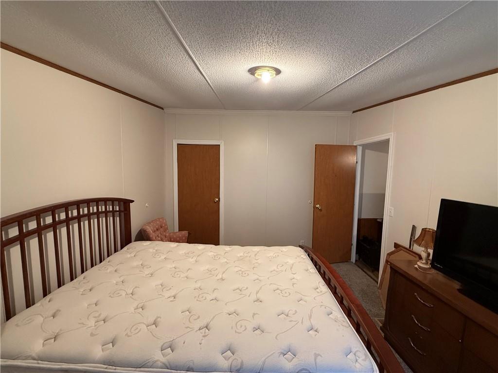 1106 Gary Road Rockwood, PA 15557 - Photo 30 of 46 a bedroom with a bed and a flat screen tv