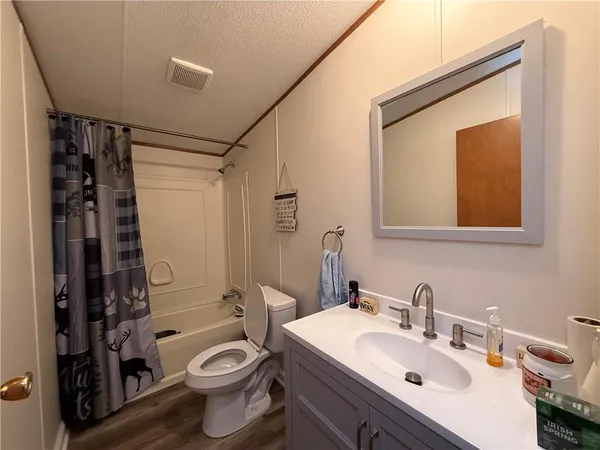 a bathroom with a sink toilet tub and shower