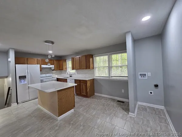 a kitchen with counter top space and stainless steel appliances