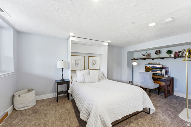 7935 Mustang Loop Road Park City, UT 84098 - Photo 36 of 60 Recessed wall bed frame with integrated lighting, wood-finish shelving, and light-toned carpeting
