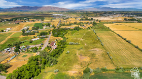 19 East Southfield Road Spanish Fork, UT 84660 - Photo 26 of 74 View of property location featuring rural landscape, farmland, and a mountainous background