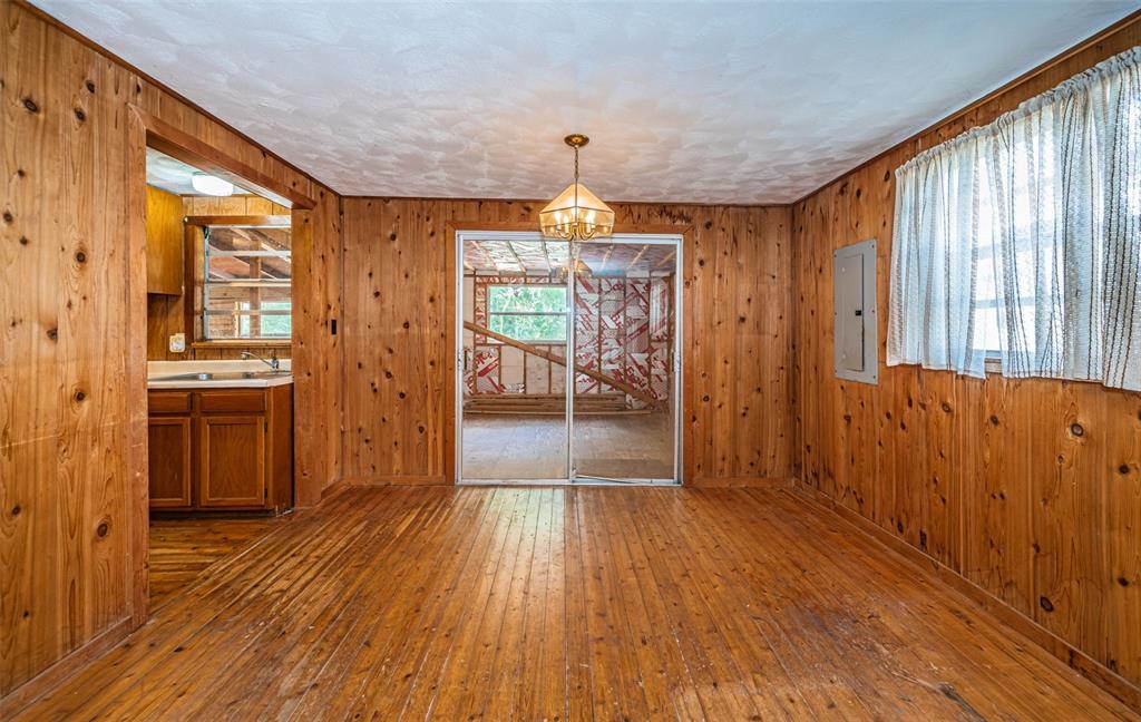 6423 Bass Road Weeki Wachee, FL 34607 - Photo 12 of 49 a view of a hallway with wooden floor and a living room