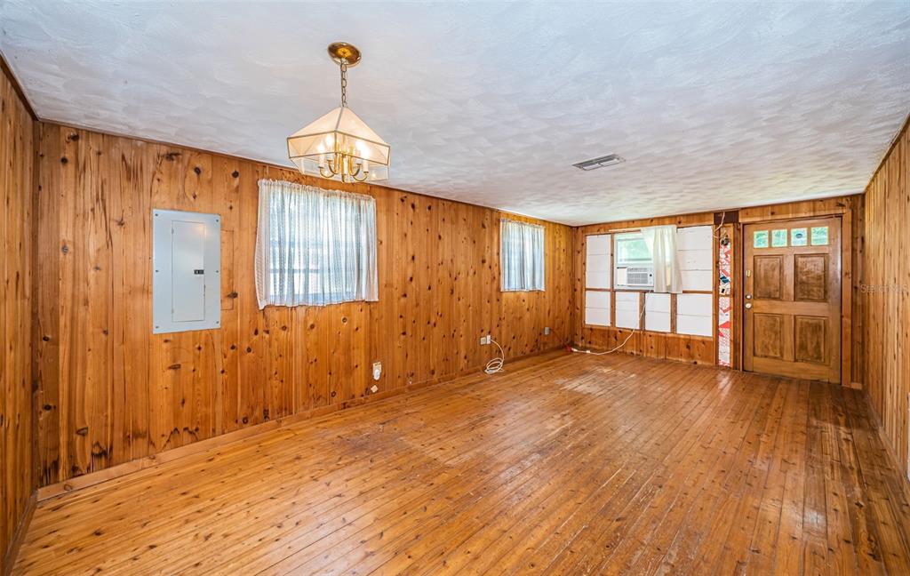 6423 Bass Road Weeki Wachee, FL 34607 - Photo 13 of 49 a view of empty room with wooden floor and fan