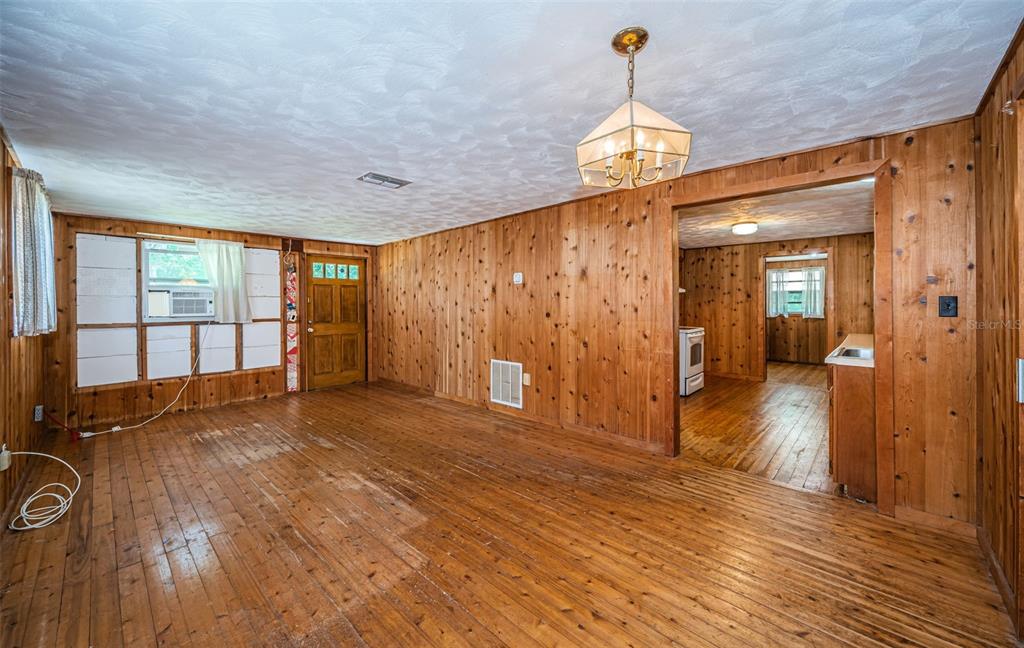 6423 Bass Road Weeki Wachee, FL 34607 - Photo 14 of 49 a view of empty room with wooden floor and fan