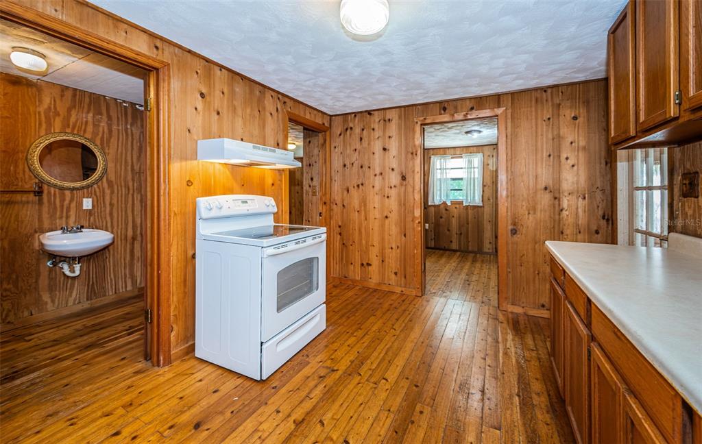 6423 Bass Road Weeki Wachee, FL 34607 - Photo 17 of 49 a kitchen with stainless steel appliances granite countertop a stove a sink and a refrigerator