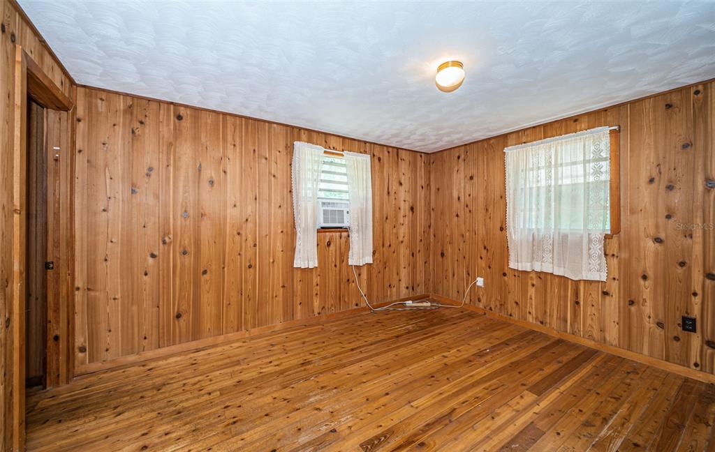 6423 Bass Road Weeki Wachee, FL 34607 - Photo 19 of 49 a view of a livingroom with wooden floor and a window