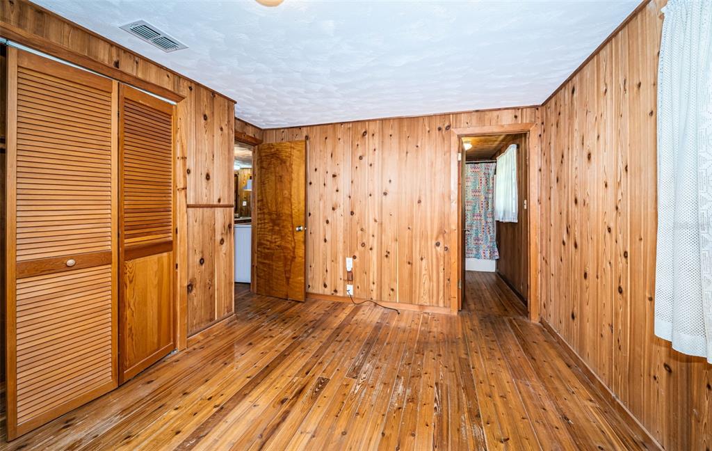 6423 Bass Road Weeki Wachee, FL 34607 - Photo 20 of 49 a view of a hallway with wooden floor and staircase