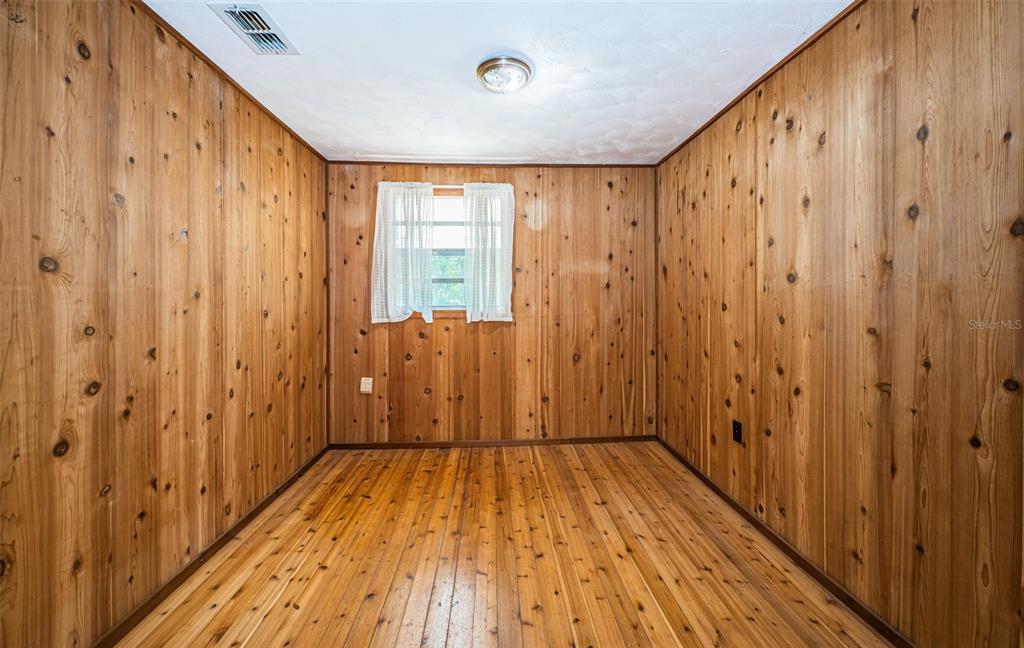 6423 Bass Road Weeki Wachee, FL 34607 - Photo 22 of 49 a view of a hallway with wooden floor