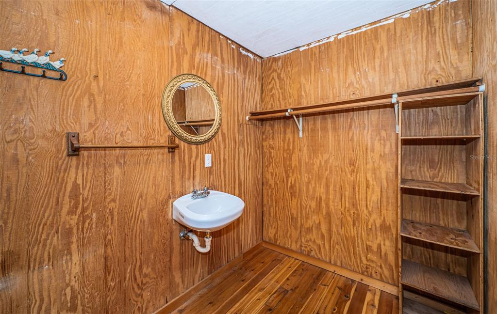 6423 Bass Road Weeki Wachee, FL 34607 - Photo 23 of 49 a bathroom with a sink a toilet and shower