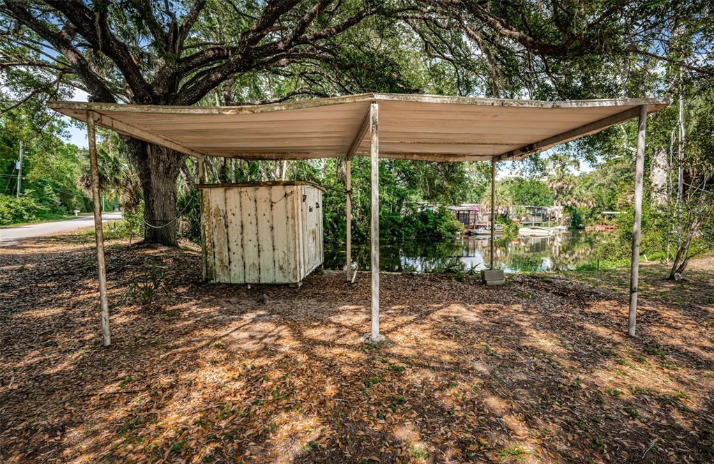 6423 Bass Road Weeki Wachee, FL 34607 - Photo 41 of 49 a backyard of a house with green space