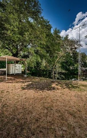 a view of a backyard with large trees