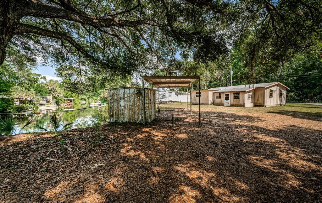 6423 Bass Road Weeki Wachee, FL 34607 - Photo 47 of 49 a house with a tree in front of it