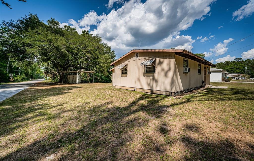 6423 Bass Road Weeki Wachee, FL 34607 - Photo 48 of 49 a view of a house with a yard