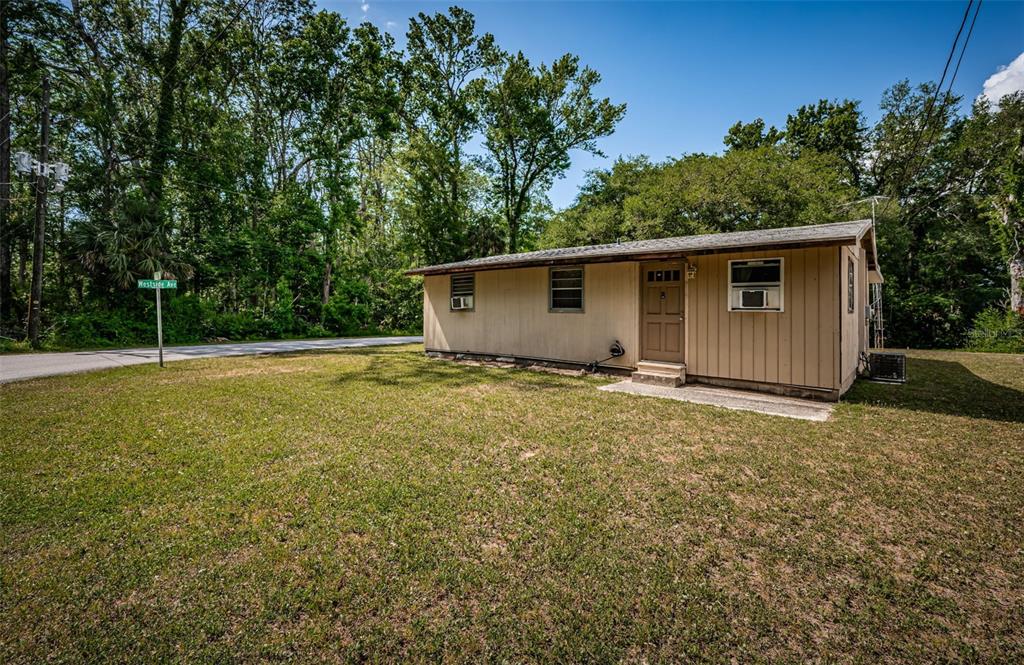 6423 Bass Road Weeki Wachee, FL 34607 - Photo 5 of 49 a backyard of a house with lots of green space