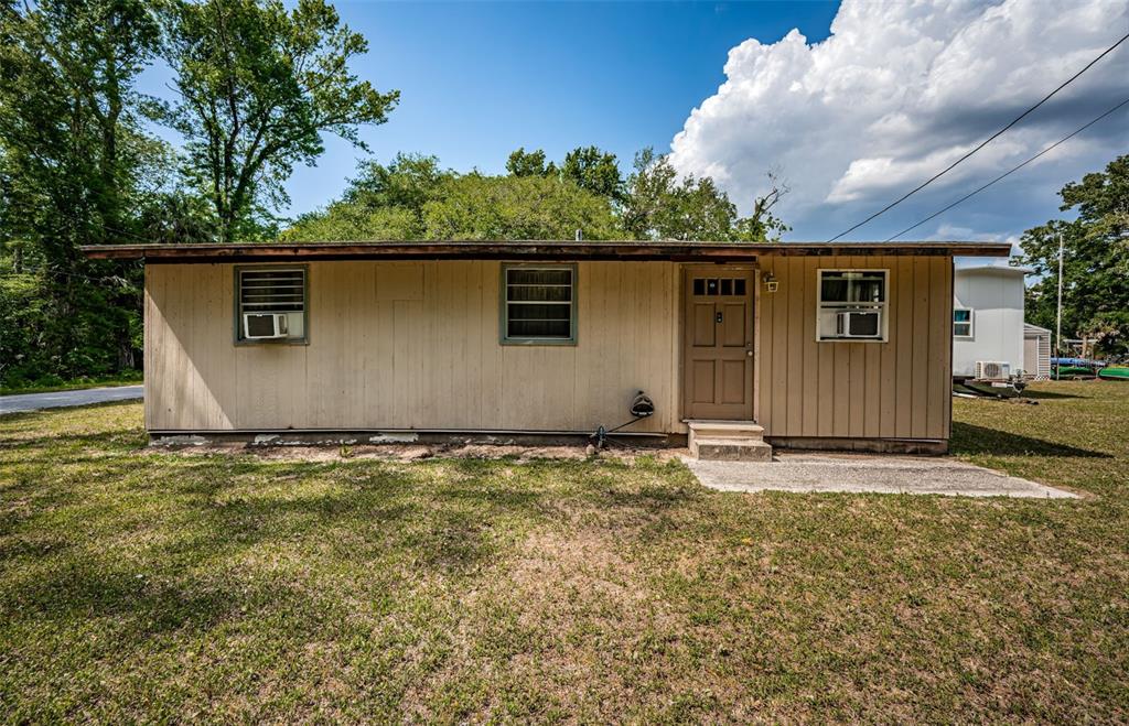 6423 Bass Road Weeki Wachee, FL 34607 - Photo 7 of 49 front view of a house with a yard